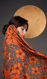 a woman in a dress with flowers and orange petals