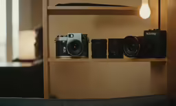 a long wooden shelf with two cameras on it