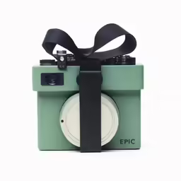 a camera that is green with black ribbon