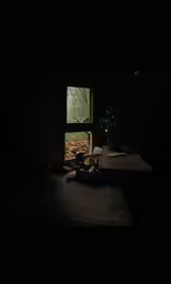 a table with two books on it in front of an open window