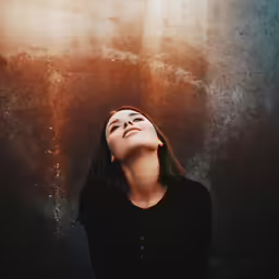 a beautiful woman standing in front of a window
