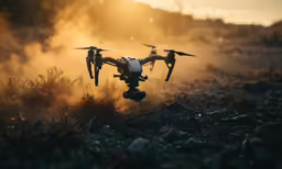 two black and white planes flying on top of a grass covered field