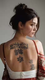 a woman with tattoos is posing for the camera