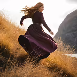 a beautiful young woman is running through tall grass