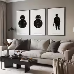 three pictures hang above a sofa and coffee table