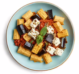 a bowl full of pasta and vegetables on a table