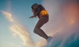 woman floating in the sky on a sunny day
