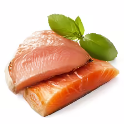 two raw portions of fish with fresh leaves on top
