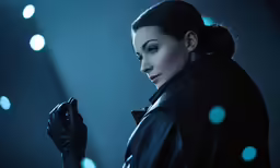a woman in a black coat is holding a cell phone