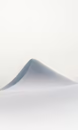 snow that is covering the top of a hill