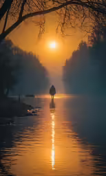 a person walking on the beach in the early morning