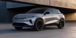 a silver electric suv parked in front of a tunnel