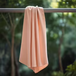 a peach colored scarf hanging up outside