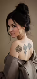 girl with tattoo on her shoulder and neck