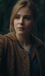 a blonde haired woman looking into the camera