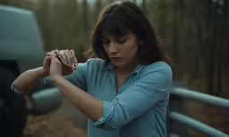 a woman putting her hands together and touching her wrist