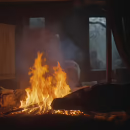 a fire burns brightly in the night in front of a living room