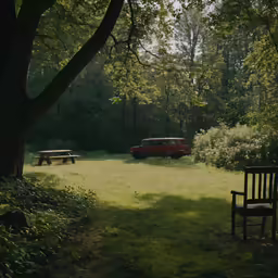 a bench and two cars in the background