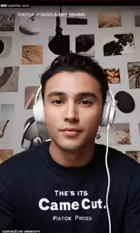 a man wearing headphones sits in front of some assorted pictures