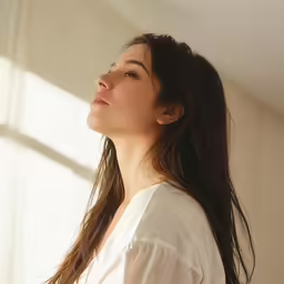 a woman looking into the distance in a room