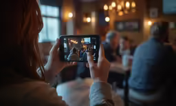 a woman taking a photo on her cell phone
