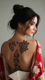 woman with her back tattoo showing flowers on her back