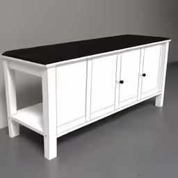 an old white sideboard with black top on display