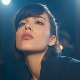 a woman with her eyes closed staring at something
