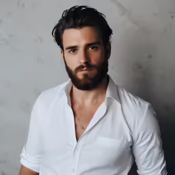 a man with long hair wearing a white shirt