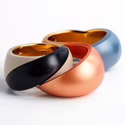 three shiny objects made to look like egg rings