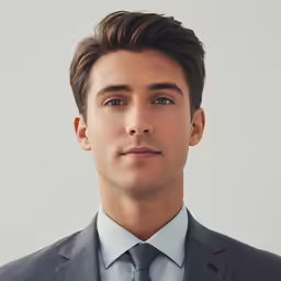 a close up of a young man in a suit and tie