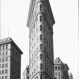 an old picture of tall buildings against the sky