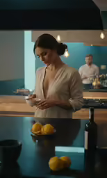 woman standing at counter, eating from bowl in kitchen
