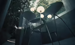 four modern lamps next to an abstract sculpture