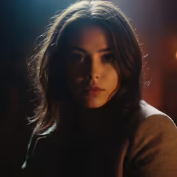 a girl staring straight ahead in the dark