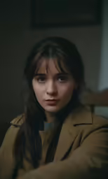 a close up of a person sitting down with dark hair