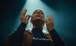 a woman with her hands on her hair