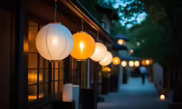 lights hanging from the side of a building on a street