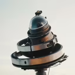 a telescope is sitting on top of a pole