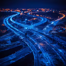 a night shot of freeway and bridges in the city