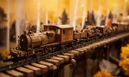 a close up of a model train on train tracks