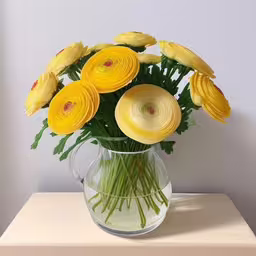 the vase is holding an arrangement of yellow flowers,there are yellow flowers that can be found in the vase,a large yellow flower arrangement in a clear vase,a vase with yellow flowers inside sitting on a table,yellow flowers arranged in a glass vase with water