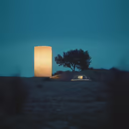 a small car drives past a lamppost