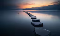 a jetty near a calm body of water
