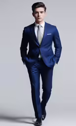 a man in a blue suit standing next to a gray wall