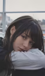 a woman with long hair and wearing a sweater