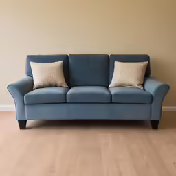 this is a blue couch with two pillows