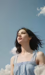 a young lady looking up into the sky with her eyes closed