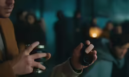 people standing around and holding cameras in their hands