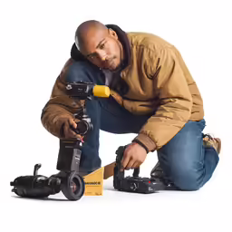 a man in winter clothing with two cameras